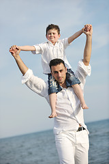 Image showing happy father and son have fun and enjoy time on beach