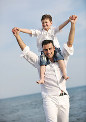 Image showing happy father and son have fun and enjoy time on beach