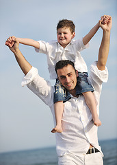 Image showing happy father and son have fun and enjoy time on beach