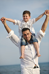 Image showing happy father and son have fun and enjoy time on beach