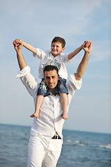 Image showing happy father and son have fun and enjoy time on beach