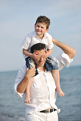 Image showing happy father and son have fun and enjoy time on beach