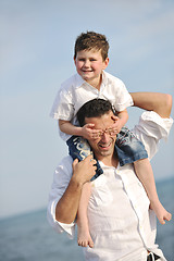 Image showing happy father and son have fun and enjoy time on beach