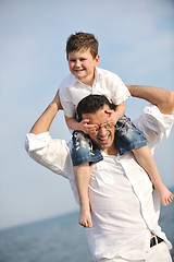 Image showing happy father and son have fun and enjoy time on beach