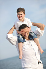 Image showing happy father and son have fun and enjoy time on beach