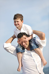 Image showing happy father and son have fun and enjoy time on beach