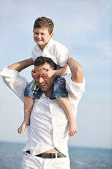 Image showing happy father and son have fun and enjoy time on beach