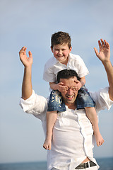 Image showing happy father and son have fun and enjoy time on beach