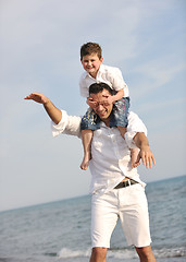 Image showing happy father and son have fun and enjoy time on beach