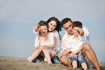 Image showing happy young family have fun on beach