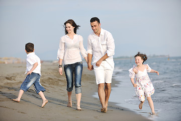 Image showing happy young family have fun on beach