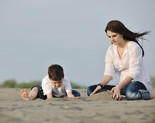 Image showing mom and son relaxing on beach