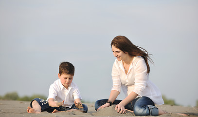 Image showing mom and son relaxing on beach