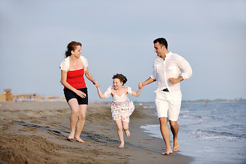 Image showing happy young family have fun on beach