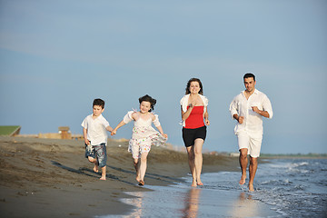 Image showing happy young family have fun on beach