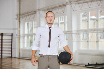 Image showing businessman holding basketball ball
