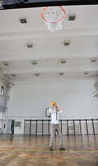 Image showing businessman holding basketball ball