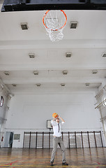 Image showing businessman holding basketball ball