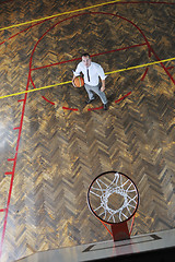 Image showing businessman holding basketball ball