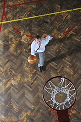 Image showing businessman holding basketball ball