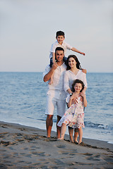 Image showing happy young family have fun on beach