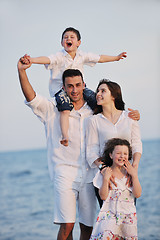 Image showing happy young family have fun on beach