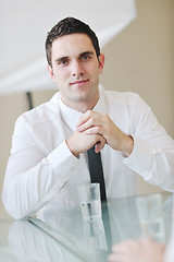 Image showing young business man alone in conference room