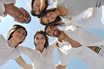 Image showing Group of happy young people in circle at beach