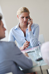 Image showing young business woman talk by cellphone on meetng