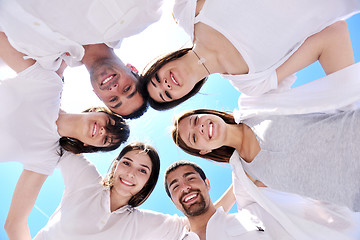 Image showing Group of happy young people in circle at beach