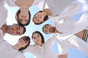 Image showing Group of happy young people in circle at beach