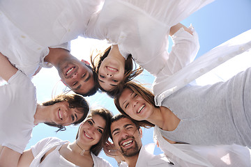 Image showing Group of happy young people in circle at beach