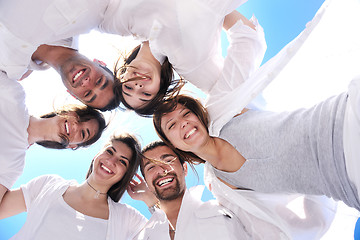 Image showing Group of happy young people in circle at beach