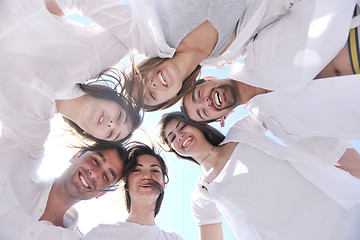 Image showing Group of happy young people in circle at beach