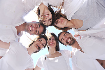 Image showing Group of happy young people in circle at beach