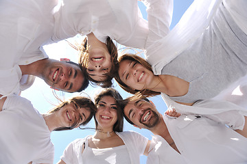 Image showing Group of happy young people in circle at beach