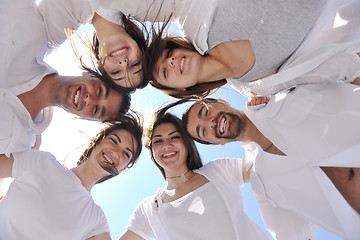 Image showing Group of happy young people in circle at beach