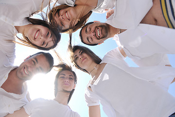 Image showing Group of happy young people in circle at beach