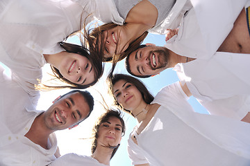 Image showing Group of happy young people in circle at beach