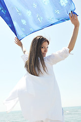 Image showing beautiful young woman on beach with scarf