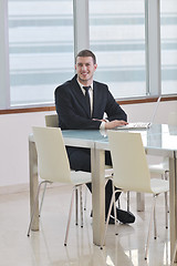 Image showing young business man alone in conference room