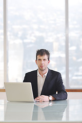 Image showing young business man alone in conference room