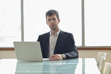 Image showing young business man alone in conference room