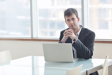 Image showing young business man alone in conference room