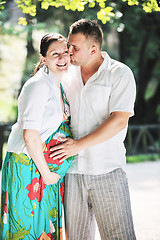 Image showing Happy pregnant couple at beautiful sunny day in park