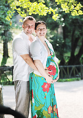 Image showing Happy pregnant couple at beautiful sunny day in park