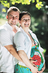Image showing Happy pregnant couple at beautiful sunny day in park