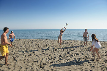 Image showing young people group have fun and play beach volleyball