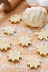 Image showing Kitchen utensil with raw Christmas cookies