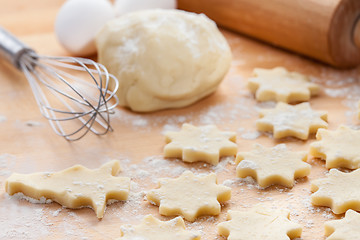 Image showing Kitchen utensil with raw Christmas cookies